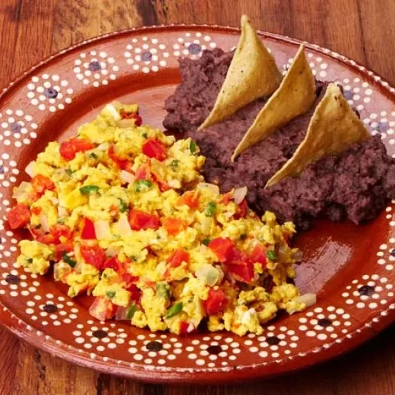 Huevo a la Mexicana with some refried beans and warm corn tortillas