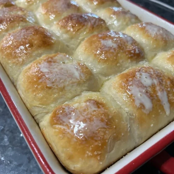 buttered sourdough dinner rolls hot from the oven