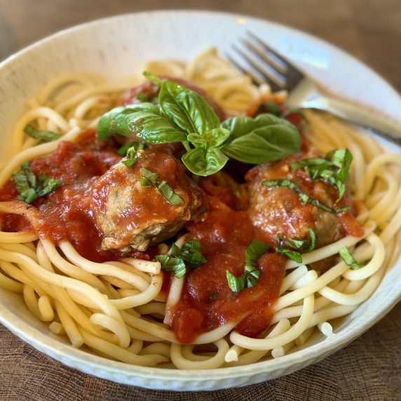 Spaghetti and meatballs with basil