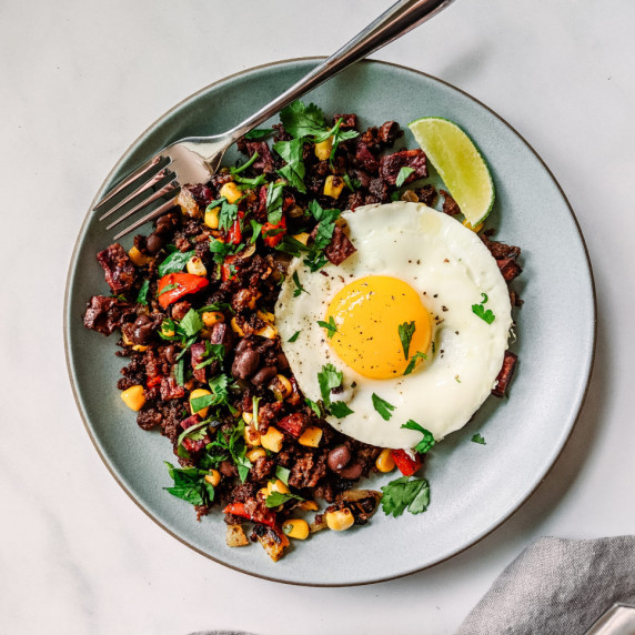 Breakfast hash with overeasy egg on plate 
