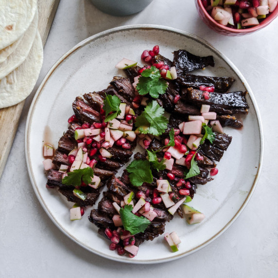 pomegranate marinade skirt steam on a white plate