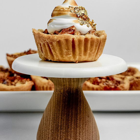 mini pecan pie tartlet on a cake stand