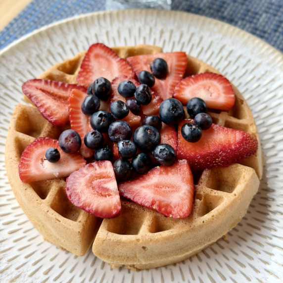 a grain-free waffle with strawberry and blueberries