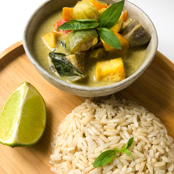 Green Curry in a bowl with a side of rice