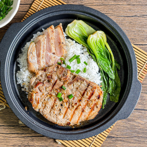 Top-view of Vietnamese lemongrass pork chops with rice and choy sum.