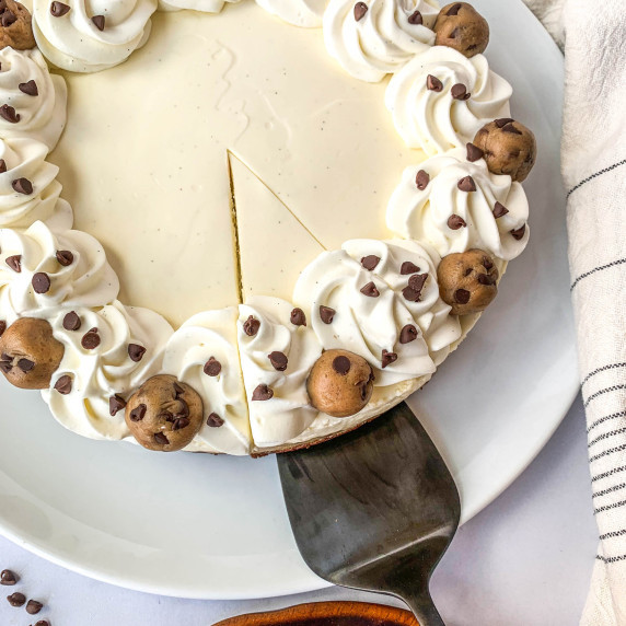 top view of  a slice cookie dough brownie cheesecake being lifted