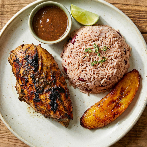 Grilled Jerk Chicken with rice and fried plantain.