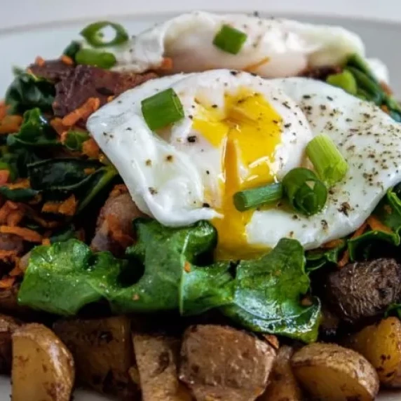 Egg on top of a kale and carrot mixture - all served on delicious hash browns.