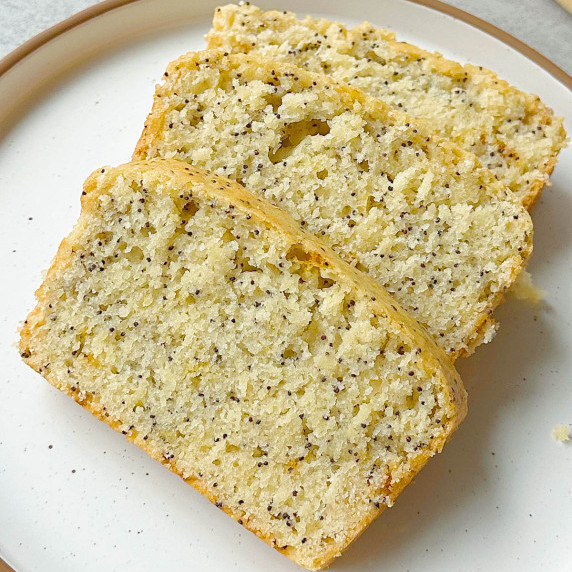 finished vegan lemon poppyseed bread on a white plate