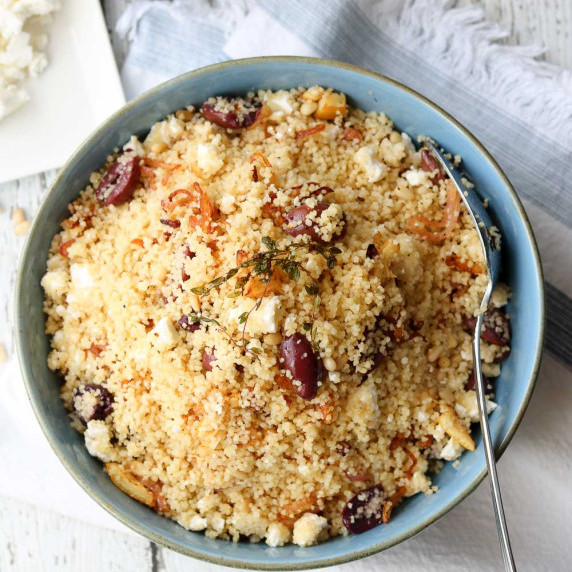 Lemon Thyme couscous with olives plated with spoon