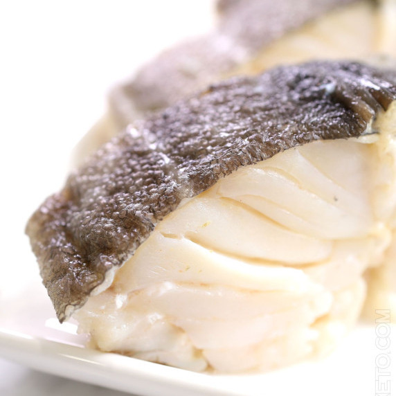 Freshly poached cod loin, just removed from the pot.