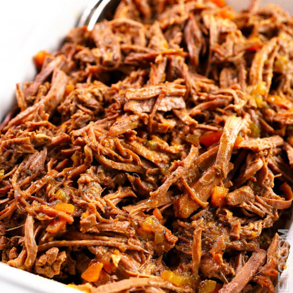 Shredded soft beef brisket mixed with thick brown gravy with bits of carrots.