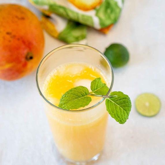 Mango agua fresca with a sprig of mint