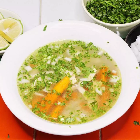 Authentic Mexican chicken soup on white bowl.