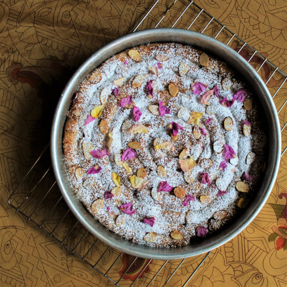 M'hanncha sprinkled with powdered sugar and dried rose petals. 
