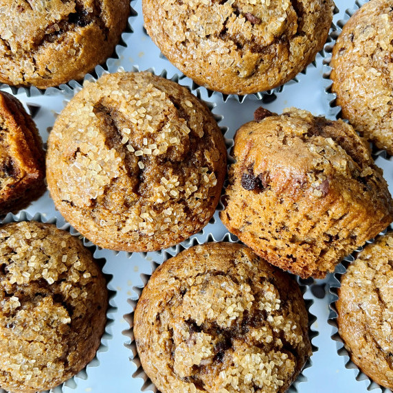 Chocolate chip muffins on a white platter.