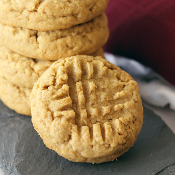 Close up of peanut butter cookies on a slate board.