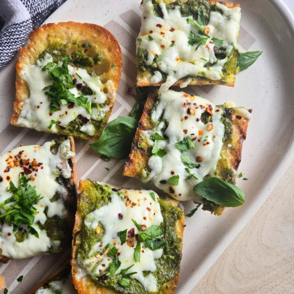 Golden baguette, green pesto and herbs, and melty mozzarella cheese