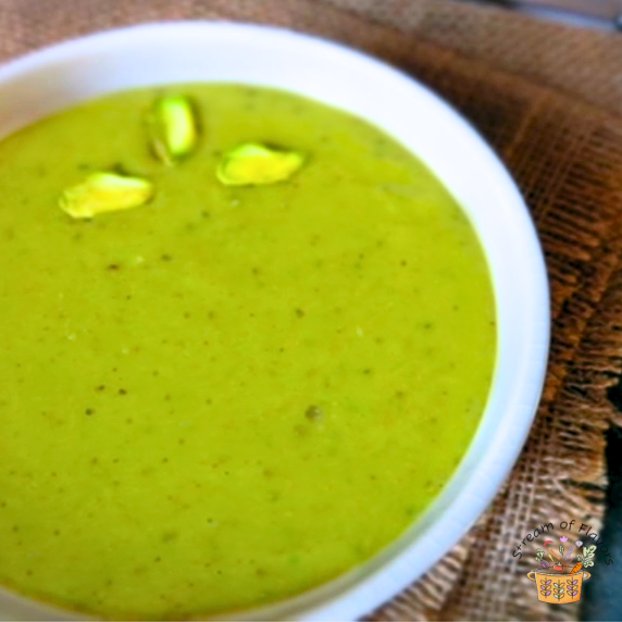 Homemade pistachio butter with macadamia nuts and walnut oil in a white bowl on brown burlap