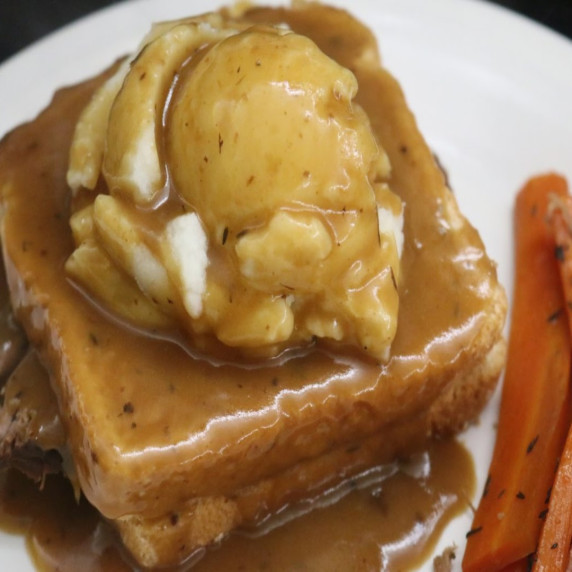 Pot Roast Sandwich topped with mashed potatoes and covered with gravy