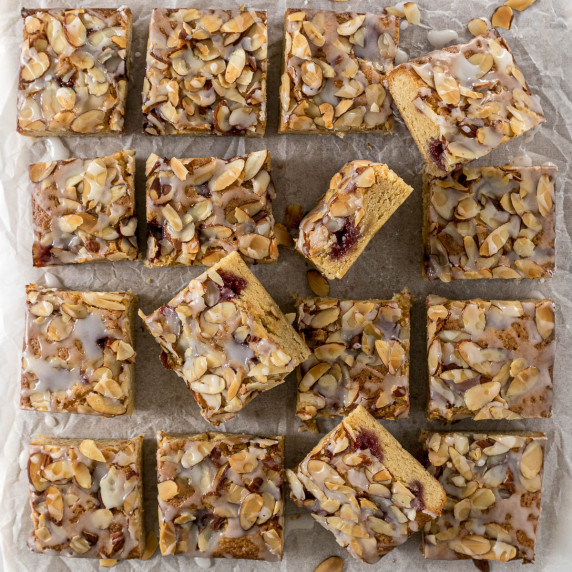 Sliced Bakewell Blondie on baking paper.