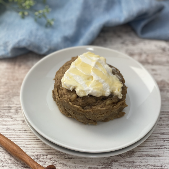 Mug muffin topped with greek yogurt on two white plates