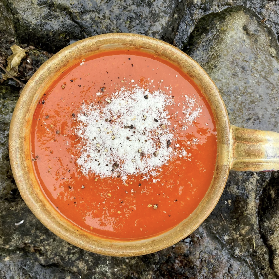 tomato soup in bowl on rocks.