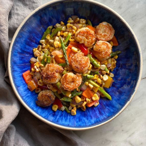 shrimp and veggies in a blue bowl.