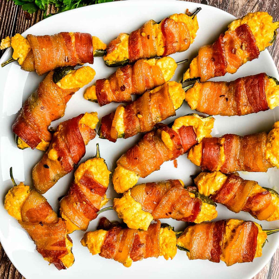 A closeup of the jalapeno poppers on a white serving tray.