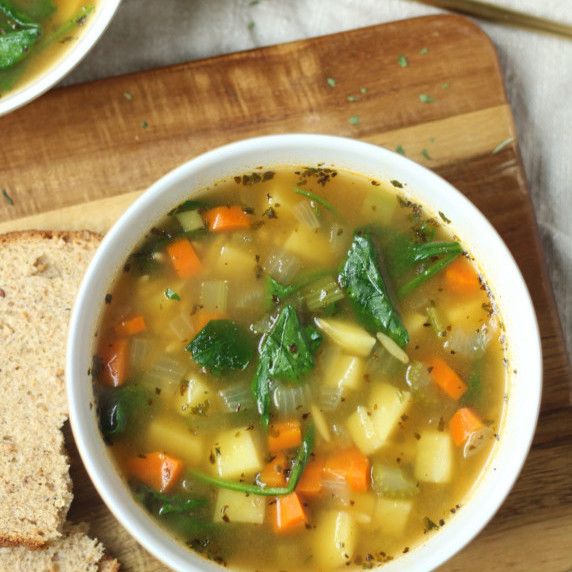 finished bowl of spinach and potato soup in a white bowl