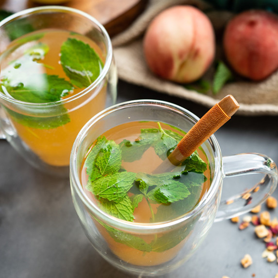 Tea with peaches, lemons, dry tea and fresh mint leaves