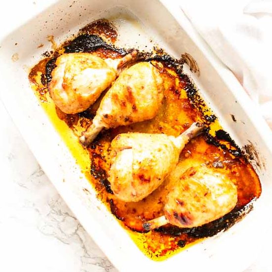 Sweet chicken drumsticks in an oven baking dish