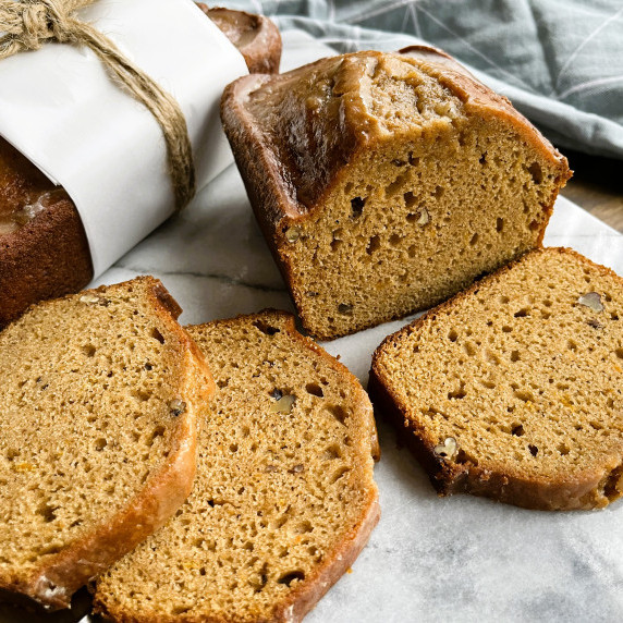 Sliced sweet potato quick bread on a marble cutting board
