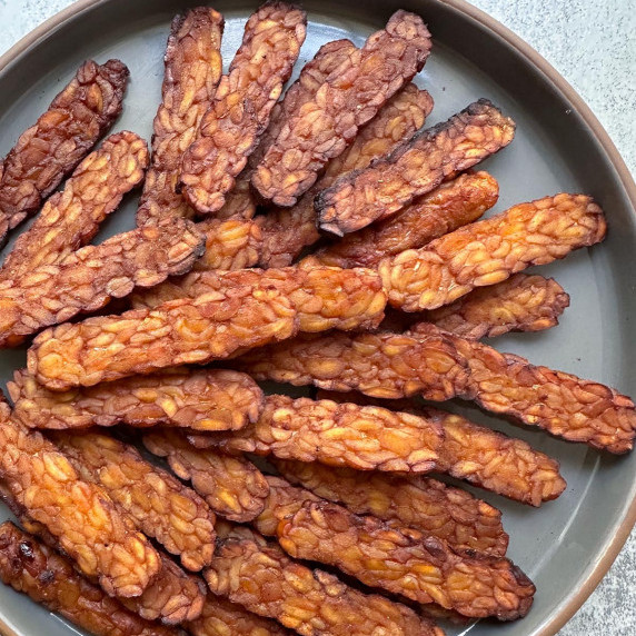 smoky maple tempeh bacon on a plate