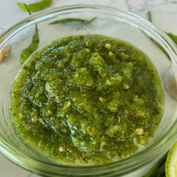 Thai green chili sauce in a glass cup.