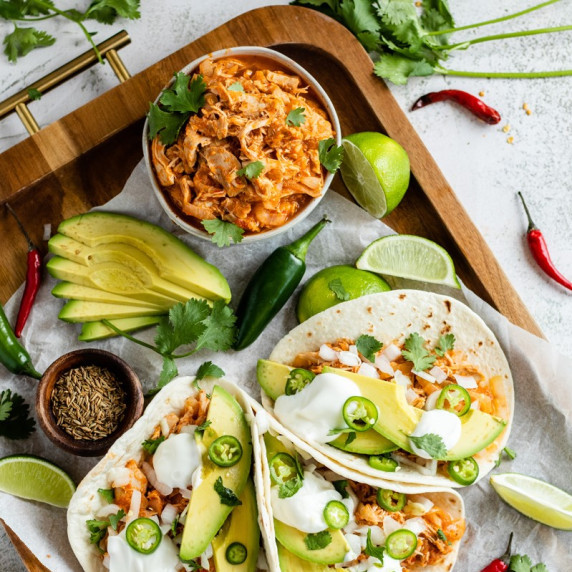 tinga de pollo in tortillas on a platter.