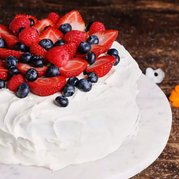 Tres leches with strawberry and berries on top.