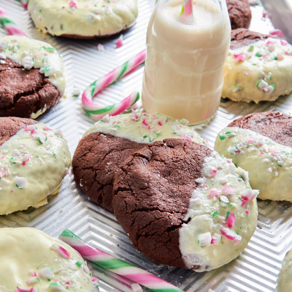 Triple Mint Chocolate Sourdough Protein Cookies on a tray, surrounded by candy canes