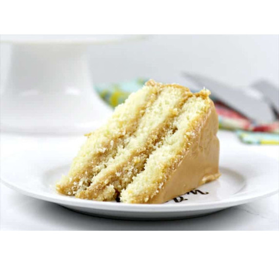 Southern caramel cake with homemade caramel icing from butter, sugar, and milk.