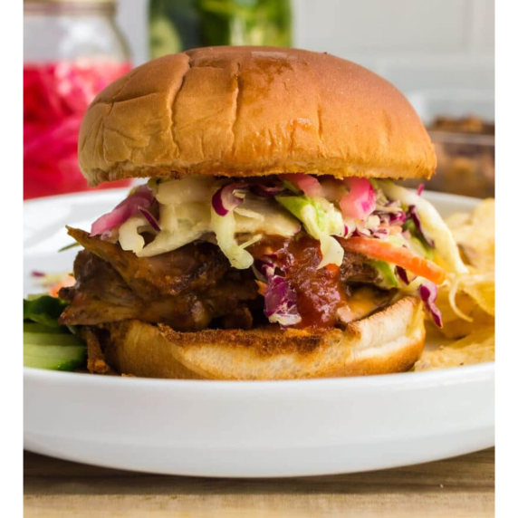 Oven Pulled Pork, seasoned with a zesty BBQ rub and dark beer, is in the oven until tender.