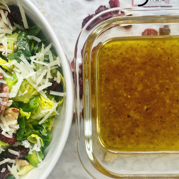 Champagne vinaigrette arranged next to a Brussels Sprouts Salad.