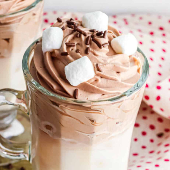 Top of the whipped hot chocolate covered with marshmallows and sprinkles.