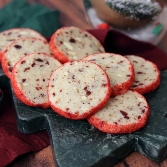 White Chocolate Cranberry Pecan Tea Cookies on a holiday plate against a white background.