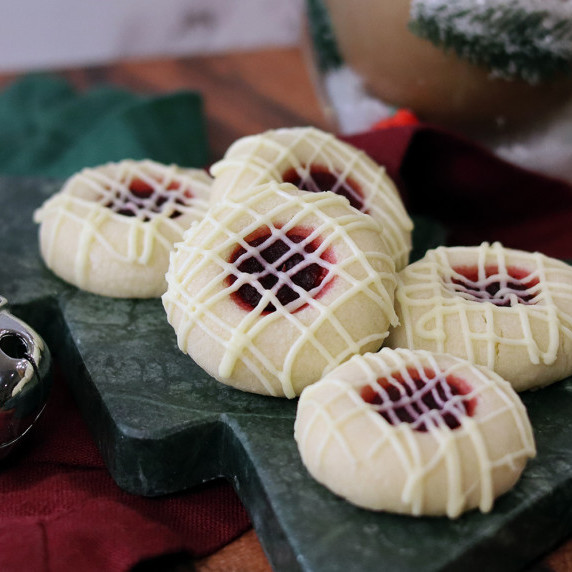 White Chocolate Cranberry Thumbprints arranged on a holiday plate