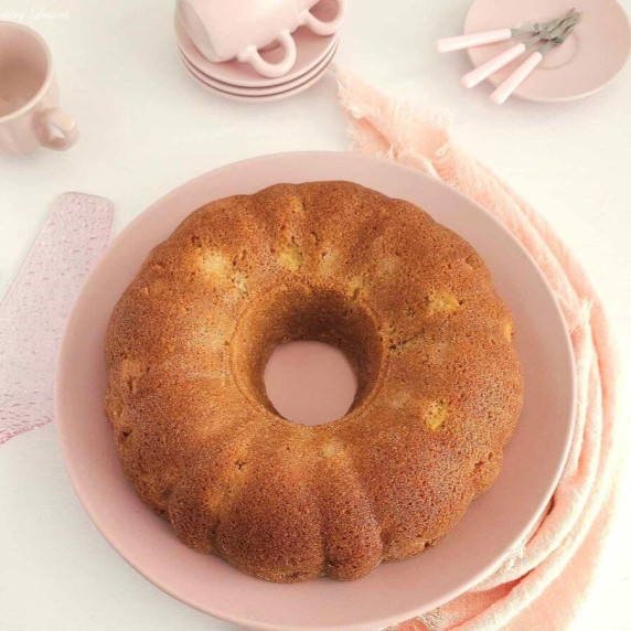Overhead close image of a golden apple cinnamon bund cake on table.
