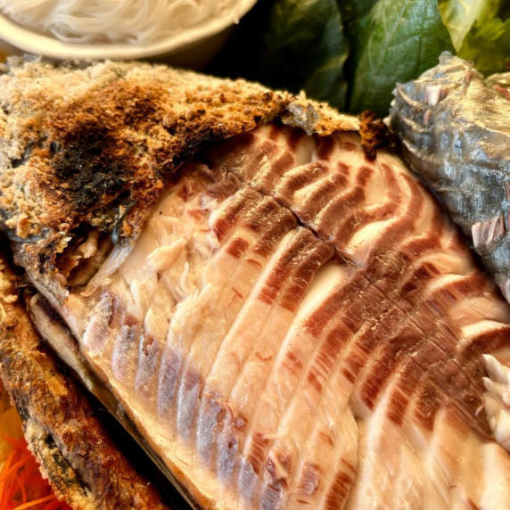 Thai grilled fish, pla pao, highlighting the perfectly grilled fish flesh.