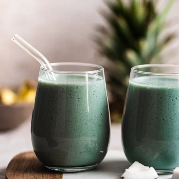 Blue Majik Smoothie place in a clear glass with straw
