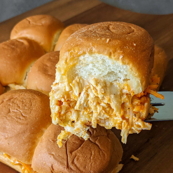 A cheesy shredded buffalo chicken slider on King's Hawaiian Rolls