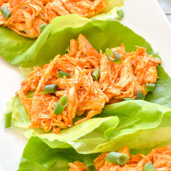 shredded buffalo chicken in lettuce ups on a plate.
