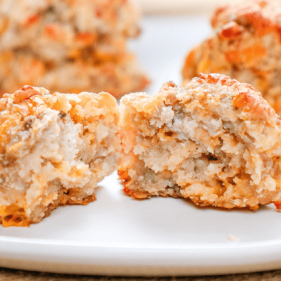 a cheddar bay biscuit sausage balls cut in half on a white plate.